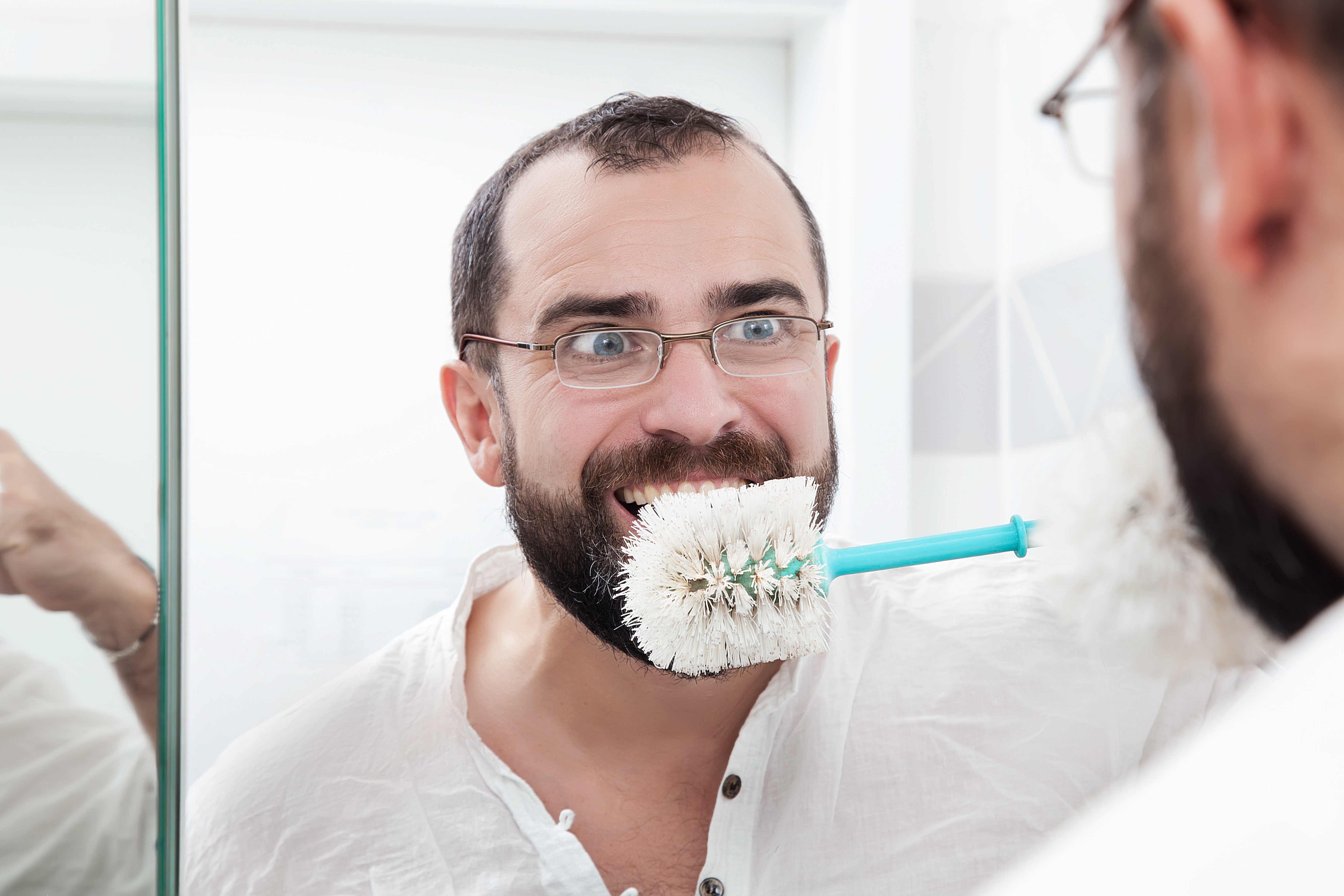 Unhygienic man brushing teeth with toilet brush
